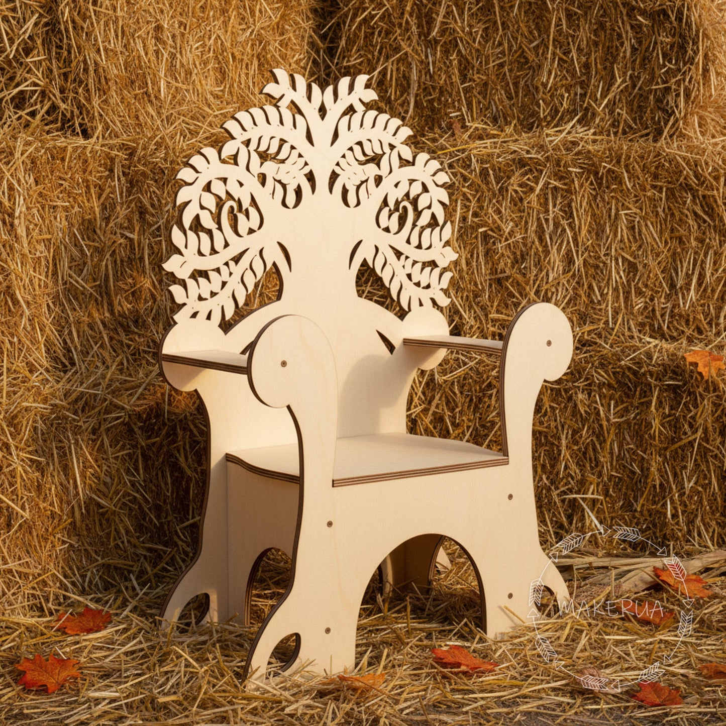 Wooden chair with tree of life design on backrest in a hay bale setting