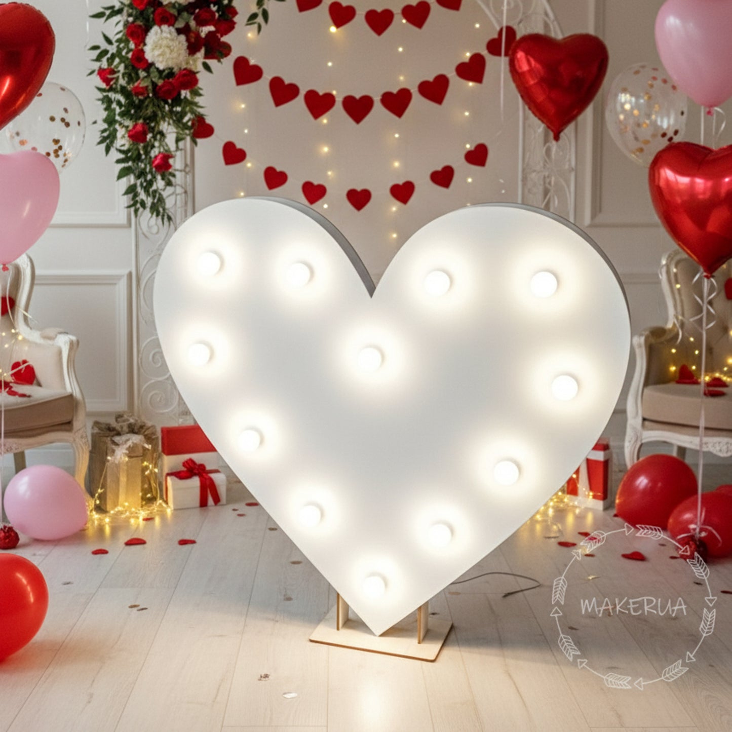 Heart-shaped led light fixture with Valentine's Day decorations including balloons and lights.