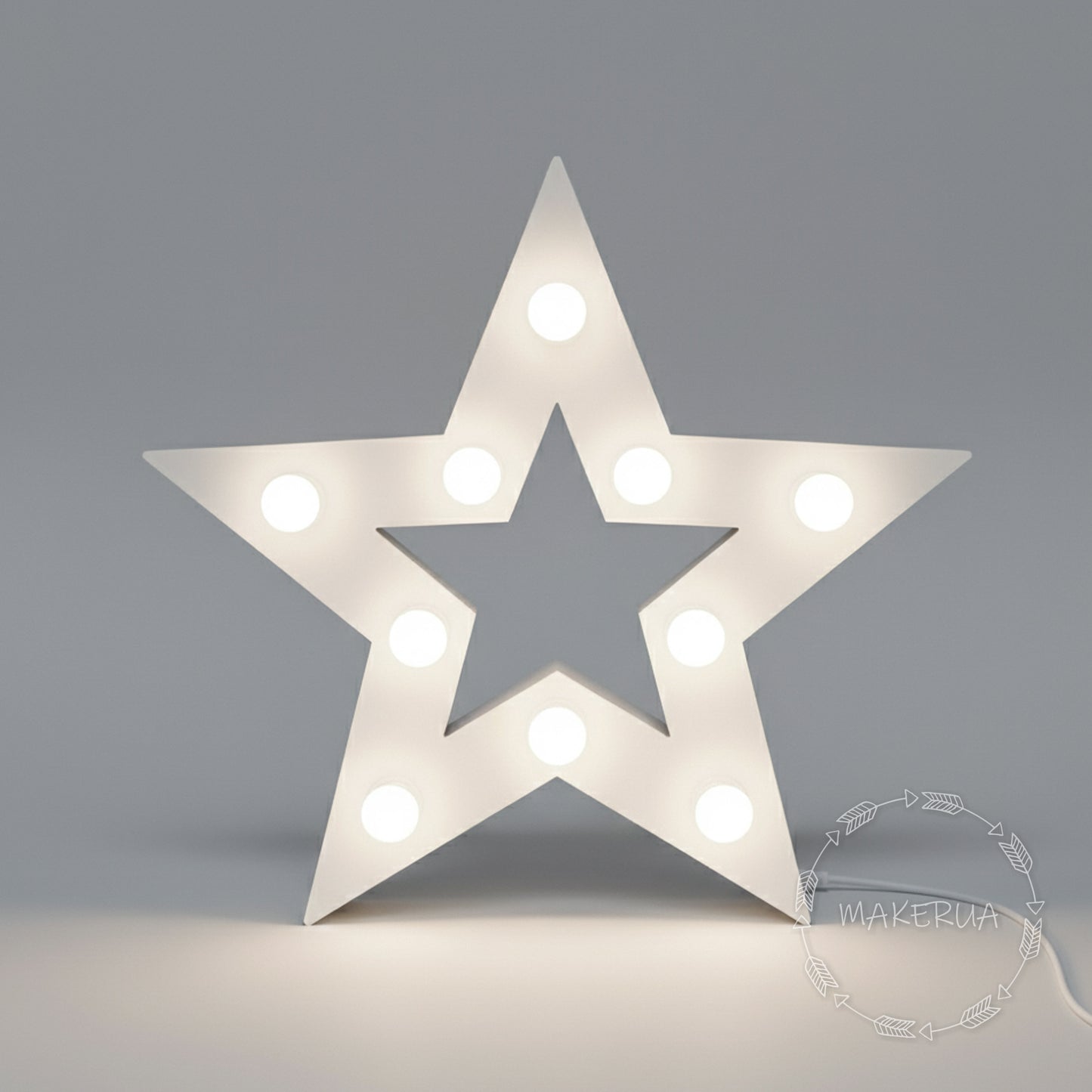 Star-shaped light fixture with bulbs on a gray background