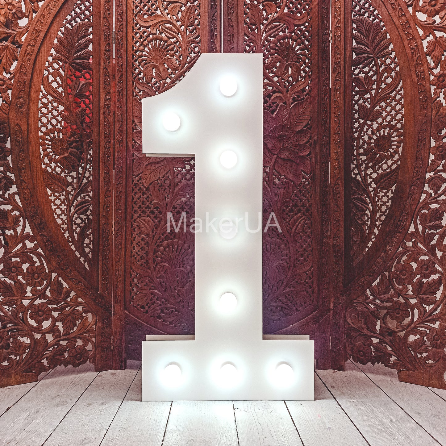 Decorative marquee number '1' with led lights against a wooden carved background for baby 1st birthday prty