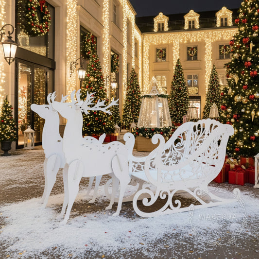 Decorative white reindeer and sleigh in front of a building with Christmas lights and trees.