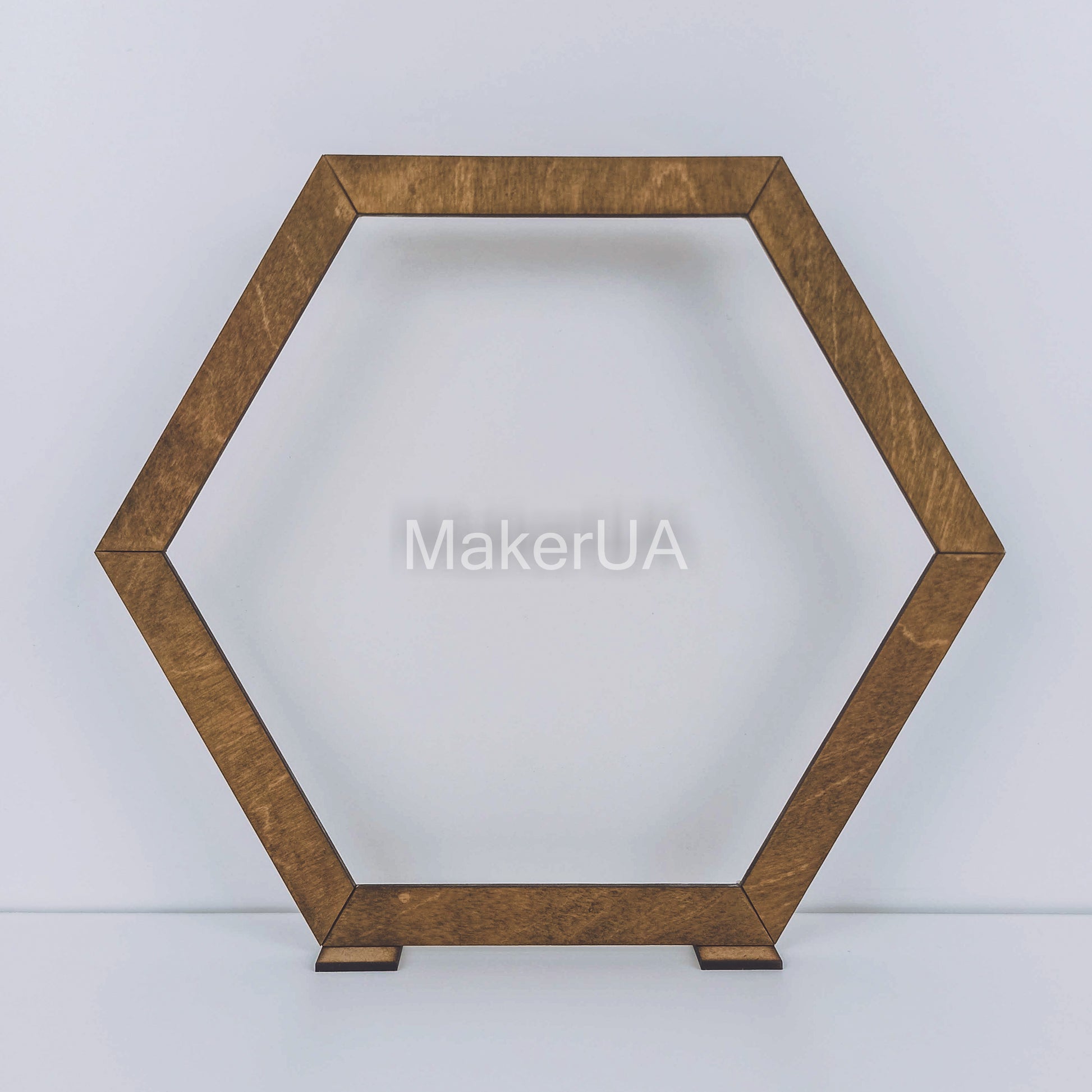 Large open hexagonal wooden arch with a natural brown wood finish. Rustic boho backdrop frame for outdoor wedding ceremonies and floral displays.
