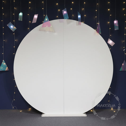 White round backdrop with colorful triangular flags against a dark blue wall with string lights