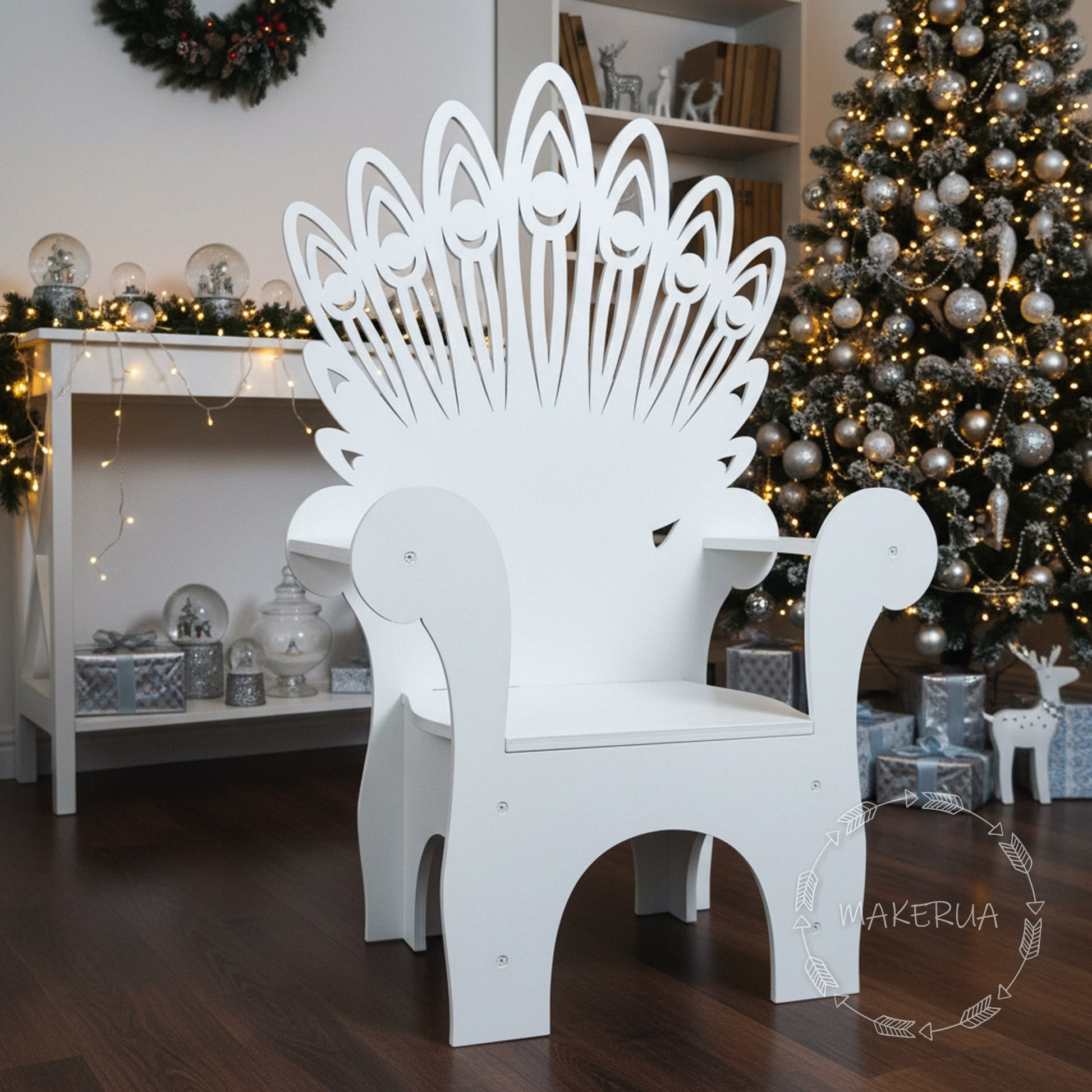 White wooden peacock throne chair with a beautifully detailed, wide flared backrest. Set in a living room with a decorated Christmas tree. Stunning boho chic photo prop for birthdays, weddings, and holiday events.