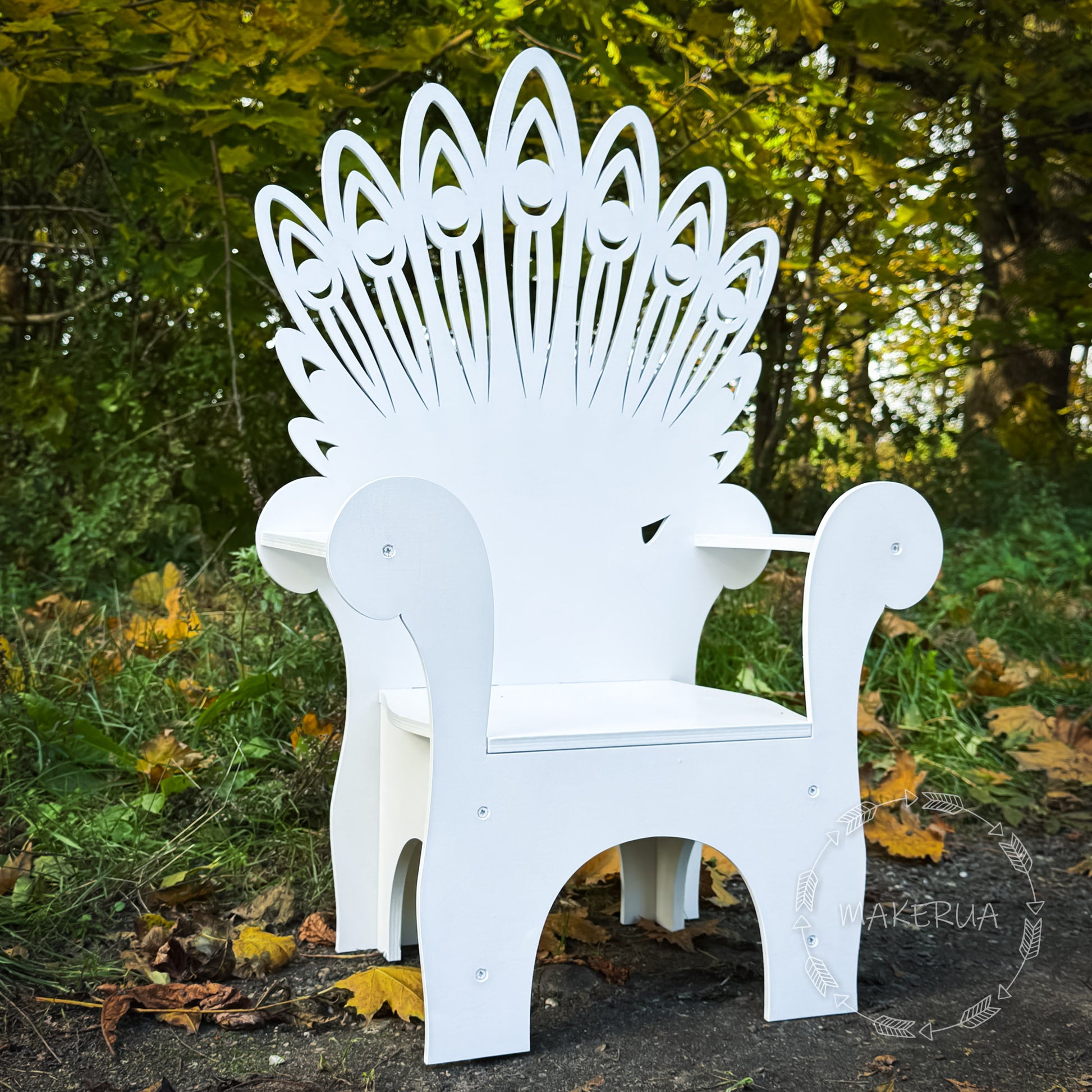 White decorative chair with intricate back design in a natural setting