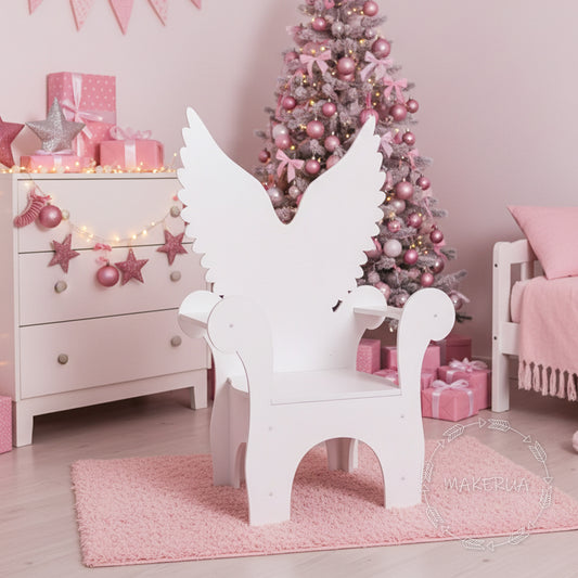 White wooden throne chair with an elegant angel wings backrest. Styled in a pink girl's bedroom next to a pink decorated Christmas tree and presents. Perfect seating prop for baby showers, christenings, and sweet birthday parties.