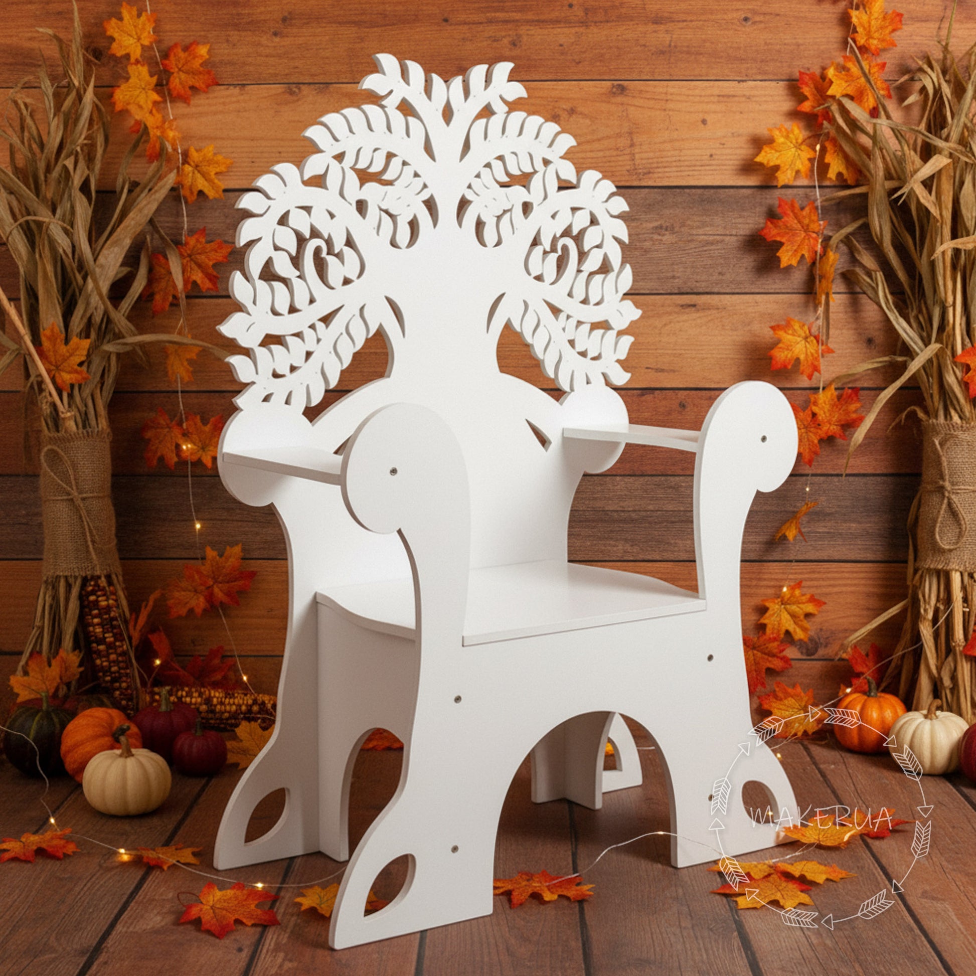 White wooden chair with tree of life design on backrest in a hay bale setting