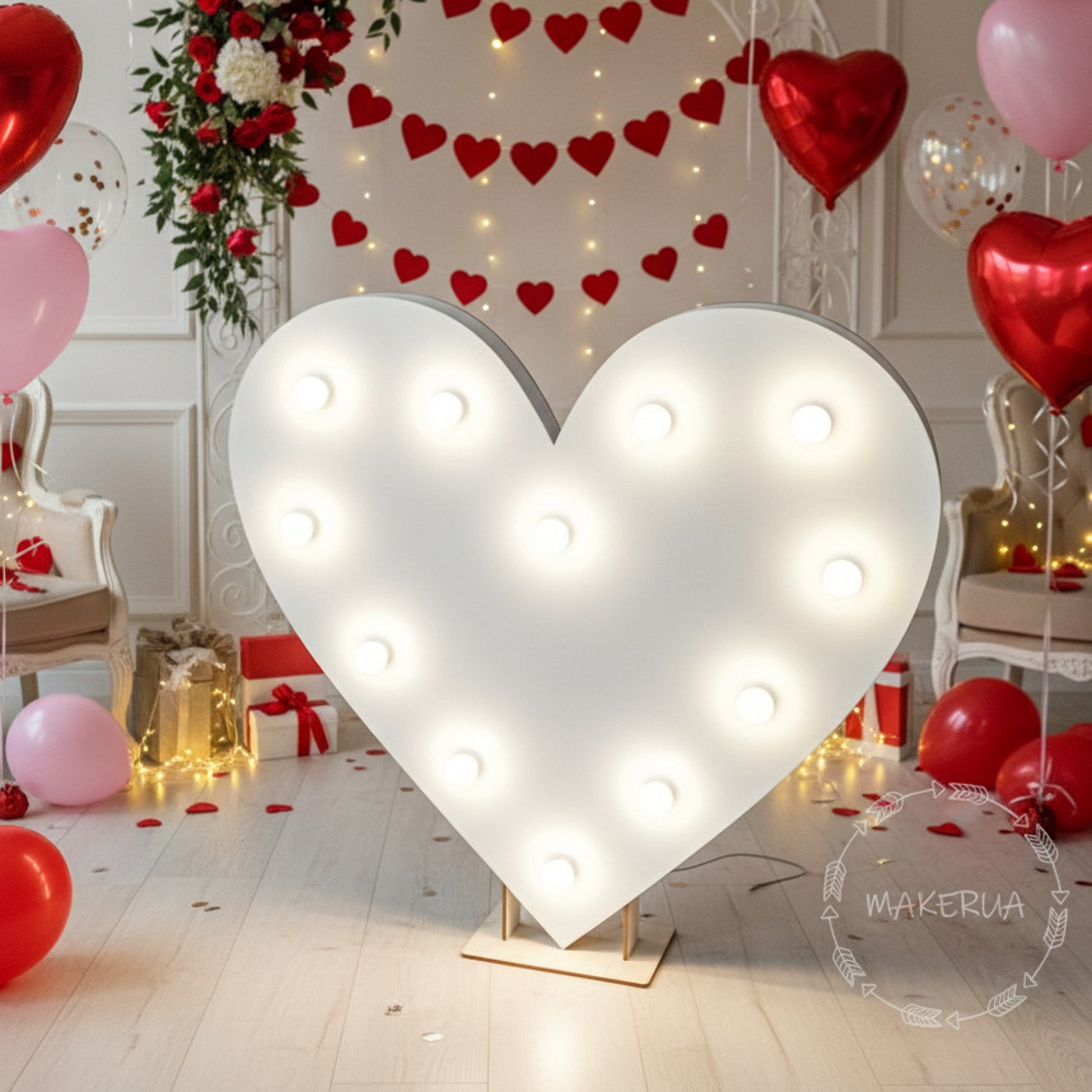 Heart-shaped led light fixture with Valentine's Day decorations including balloons and lights.