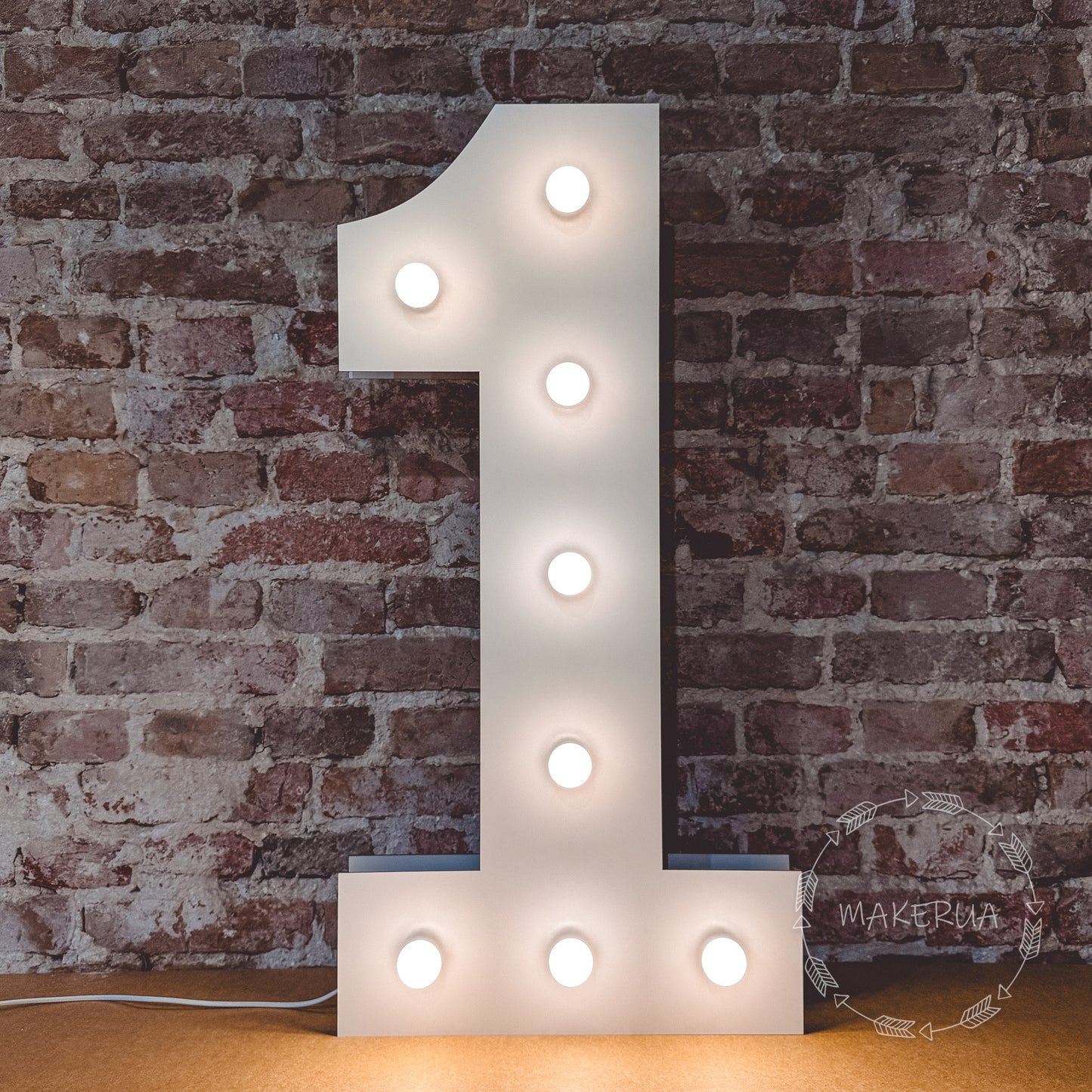 Light-up number '1' against a brick wall with led bulbs.