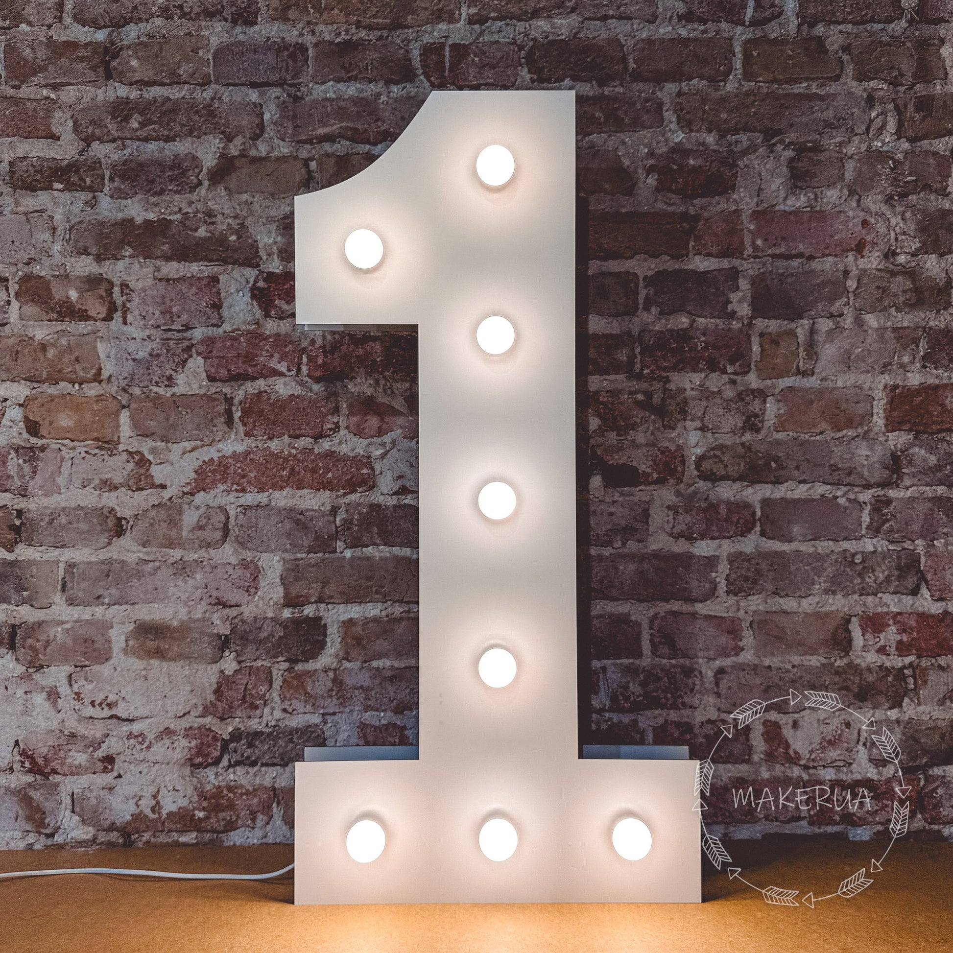 Light-up number '1' against a brick wall with led bulbs.